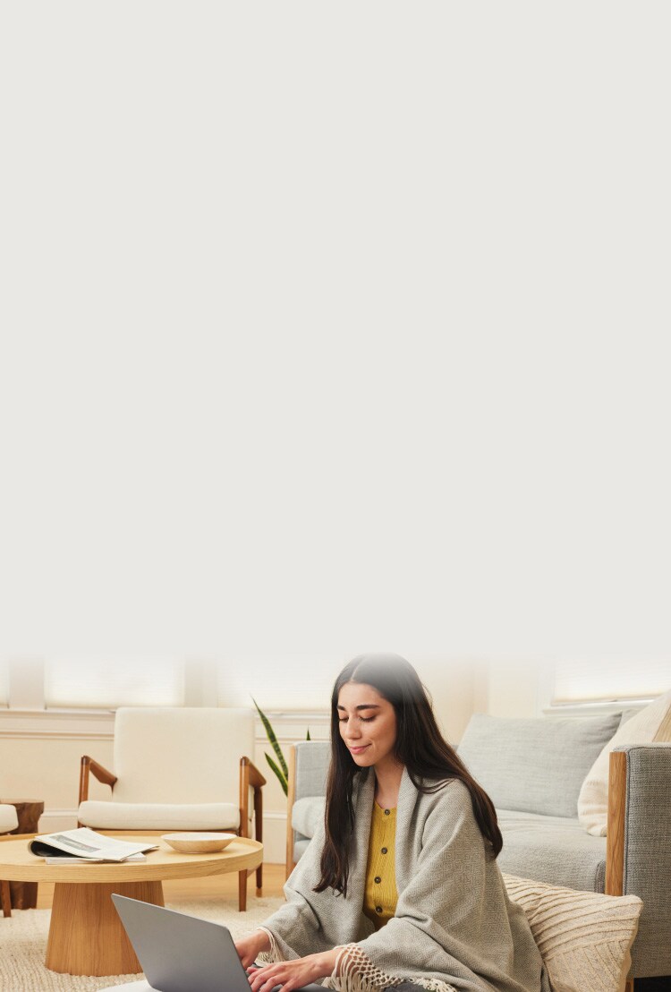 Woman working on a laptop.